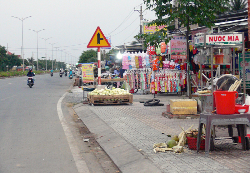 Các hộ dân bày bán hàng hóa lấn chiếm hành lang ATGT đường tỉnh 883, đoạn xã Giao Long (Châu Thành).