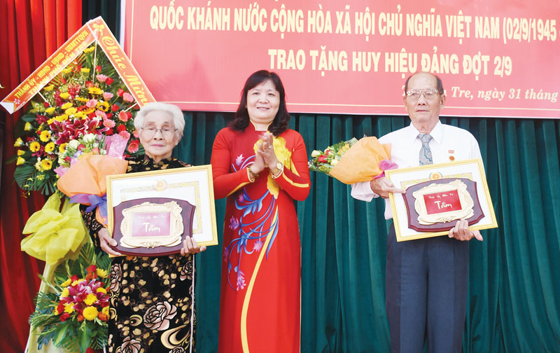 Trưởng ban Tổ chức Tỉnh ủy Hồ Thị Hoàng Yến trao huy hiệu Đảng cho đảng viên đến niên hạn tại Đảng bộ TP. Bến Tre. Ảnh: Hữu Hiệp