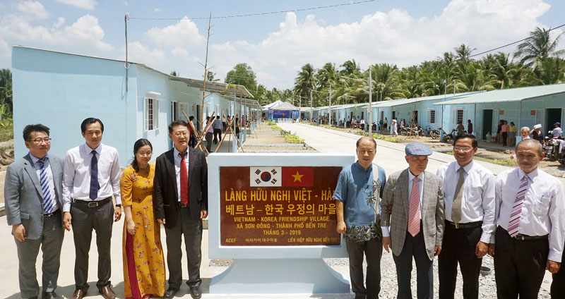 Các đại biểu cắt băng khánh thành và mở bảng tên Làng Hữu nghị Việt - Hàn tại xã Sơn Đông (TP. Bến Tre).