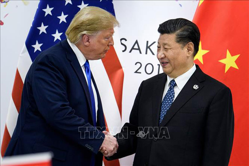 Tổng thống Mỹ Donald Trump (trái) và Chủ tịch Trung Quốc Tập Cận Bình trong cuộc gặp bên lề Hội nghị thượng đỉnh G20 tại Osaka, Nhật Bản, ngày 29/6/2019. Ảnh: AFP/TTXVN