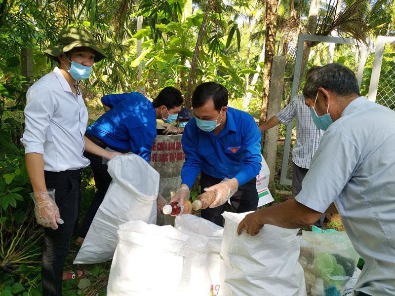 Lực lượng thu gom bao bì thuốc bảo vệ thực vật đã qua sử dụng tại vườn ông Nguyễn Văn Thật, ấp An Hòa, xã An Hiệp, huyện Châu Thành.