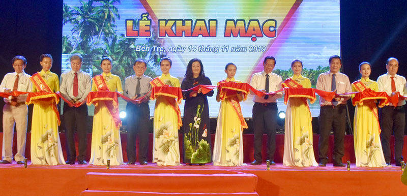 Khai mạc hội chợ triển lãm các sản phẩm dừa năm 2019 Bí thư Tỉnh ủy Phan Văn Mãi (thứ 5, phải sang) và đại biểu cắt băng khai mạc hội chợ triển lãm các sản phẩm dừa. Ảnh: Cẩm Trúc