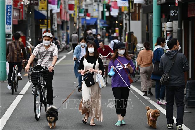 Người dân đeo khẩu trang khi đi mua sắm tại một tuyến phố ở Tokyo, Nhật Bản ngày 4-5-2020. Ảnh: AFP/TTXVN