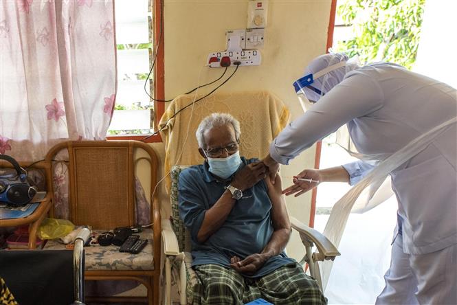 Indonesia ca lây nhiễm và tử vong mới cao nhất thế giới Nhân viên y tế tiêm vaccine ngừa COVID-19 cho người dân tại Selangor, Malaysia ngày 21-7-2021. Ảnh: THX/TTXVN