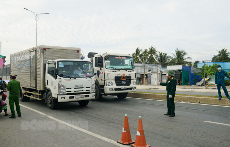 Xe chở hàng hóa qua chốt kiểm dịch cầu Rạch Miễu. Ảnh: A.Nguyệt