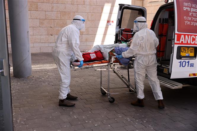  Nhân viên y tế chuyển bệnh nhân COVID-19 tới bệnh viện ở Jerusalem, ngày 15-8-2021. Ảnh: AFP/ TTXVN