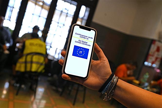 Kiểm tra chứng nhận tiêm vaccine phòng COVID-19 của khách hàng tại một nhà hàng ở Rome, Italy, ngày 6-8-2021. Ảnh: AFP/ TTXVN