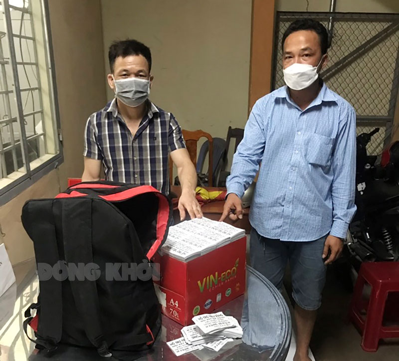 Hai đối tượng rải tờ rơi. Ảnh:Duy Quyên