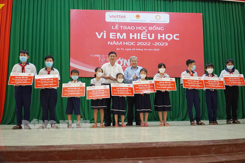 Bí thư Huyện ủy Ba Tri Võ Văn Phê và Giám đốc Sở Thông tin và Truyền thông Trịnh Minh Châu trao học bổng cho học sinh.