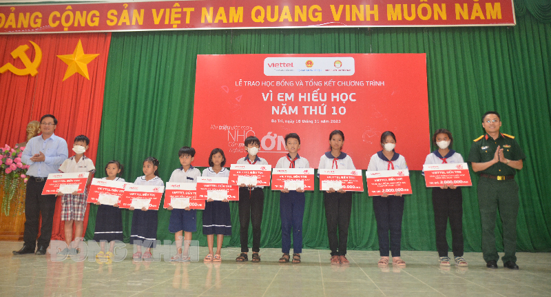 Thiếu tá Trần Văn Chiến - Giám đốc Chi nhánh Viettel Bến Tre và Phó giám đốc Sở Giáo dục và Đào tạo Võ Văn Bé Hai trao học bổng cho các em học sinh.