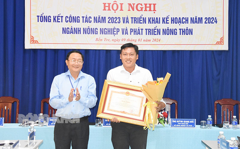 Giám đốc Sở Nông nghiệp và Phát triển nông thôn Đoàn Văn Đảnh trao bằng khen của Thủ tướng Chính phủ cho Thạc sĩ Lê Trí Nhân.